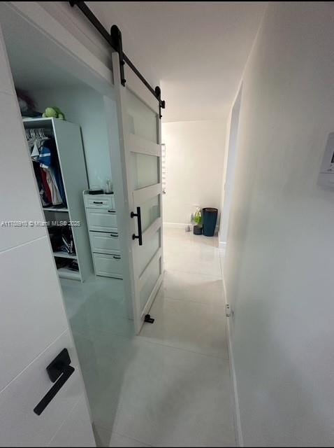 11245 SW 47th Ter, Miami, FL 33165 - hallway with a barn door and tile patterned flooring