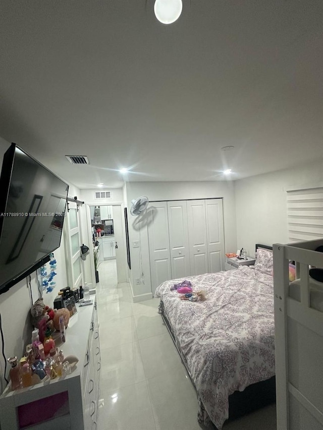 11245 SW 47th Ter, Miami, FL 33165 - bedroom featuring light tile patterned flooring, visible vents, a closet, and a barn door