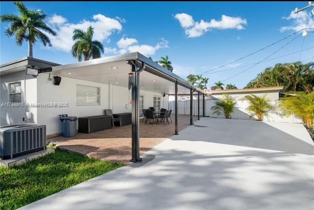 11245 SW 47th Ter, Miami, FL 33165 - view of patio / terrace with central AC unit and fence