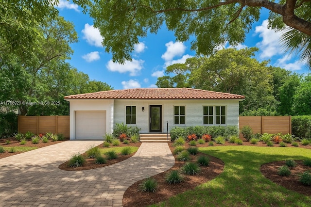 6845 SW 57th Ter, Miami, FL 33143 - view of front facade featuring a garage, a tile roof, and decorative driveway