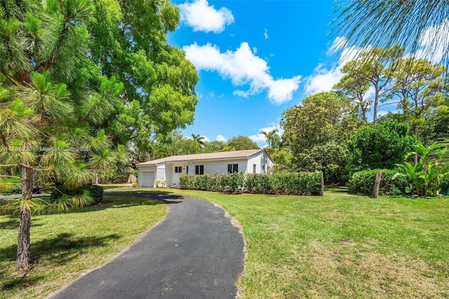 6845 SW 57th Ter, Miami, FL 33143 - view of front of home featuring an attached garage, a front lawn, stucco siding, and asphalt driveway