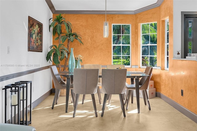 dining area featuring plenty of natural light, baseboards, and crown molding