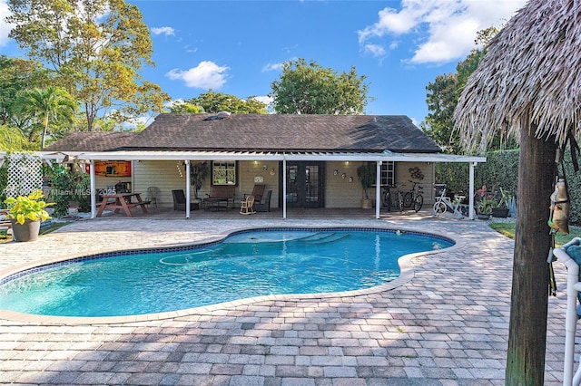 view of swimming pool with fence, a fenced in pool, french doors, and a patio