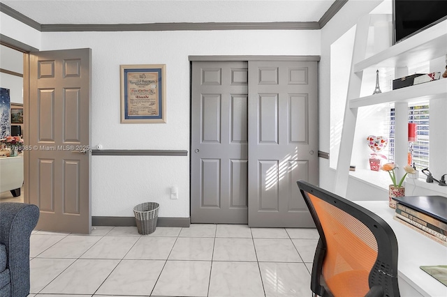 office area with baseboards, ornamental molding, and light tile patterned flooring
