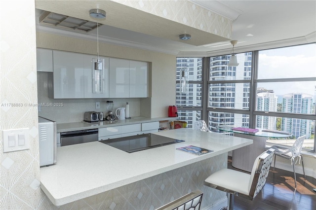 3530 Mystic Pointe Dr Unit 2910, Aventura, FL 33180 - kitchen with dishwasher, a breakfast bar, white cabinetry, black electric stovetop, and light countertops