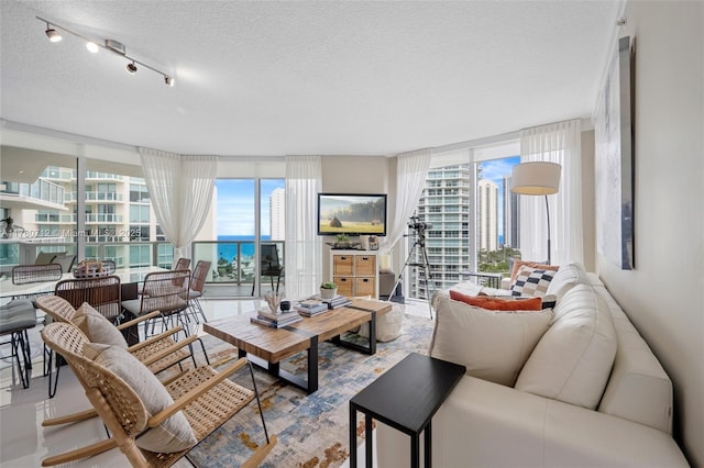 250 Sunny Isles Blvd Unit 3-1505, Sunny Isles Beach, FL 33160 - living room featuring a textured ceiling, plenty of natural light, and expansive windows