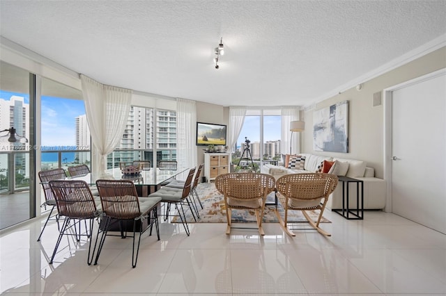 250 Sunny Isles Blvd Unit 3-1505, Sunny Isles Beach, FL 33160 - tiled dining area featuring expansive windows, a textured ceiling, a view of city, and a water view