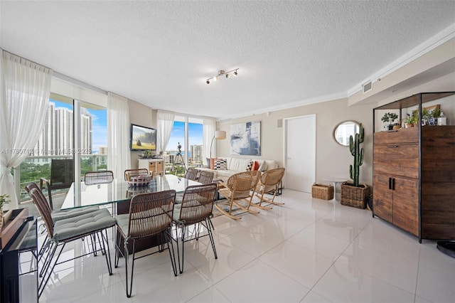 250 Sunny Isles Blvd Unit 3-1505, Sunny Isles Beach, FL 33160 - dining room featuring light tile patterned flooring, a textured ceiling, and rail lighting