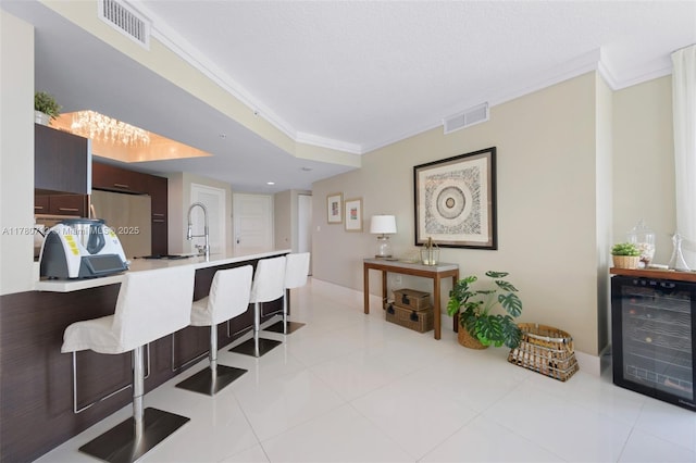 250 Sunny Isles Blvd Unit 3-1505, Sunny Isles Beach, FL 33160 - kitchen with beverage cooler, a breakfast bar, crown molding, light countertops, and modern cabinets