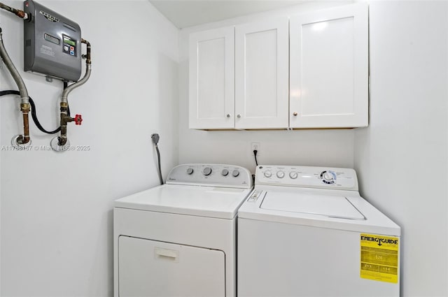 clothes washing area with cabinet space and independent washer and dryer