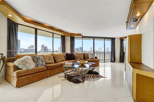 3000 Island Blvd Unit 706, Aventura, FL 33160 - tiled living area with a view of skyline, expansive windows, and a textured ceiling
