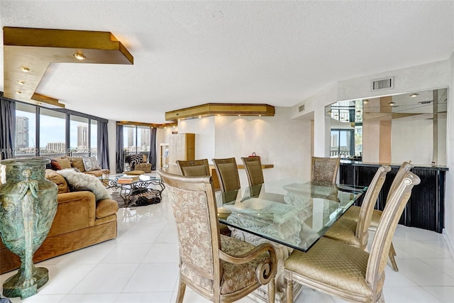 3000 Island Blvd Unit 706, Aventura, FL 33160 - dining space featuring light tile patterned flooring and a textured ceiling