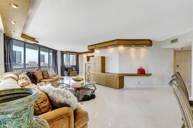 3000 Island Blvd Unit 706, Aventura, FL 33160 - living room with a textured ceiling, baseboards, and a wall of windows