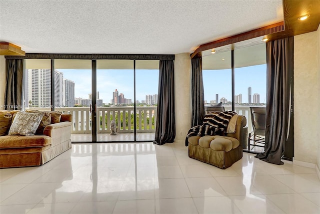3000 Island Blvd Unit 706, Aventura, FL 33160 - living room featuring a skyline view, healthy amount of natural light, a wall of windows, a textured ceiling, and tile patterned flooring