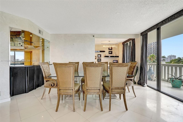 3000 Island Blvd Unit 706, Aventura, FL 33160 - dining room featuring plenty of natural light, a chandelier, a wall of windows, and a textured ceiling