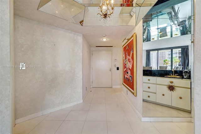 3000 Island Blvd Unit 706, Aventura, FL 33160 - hallway with a sink, a chandelier, light tile patterned floors, baseboards, and a high ceiling