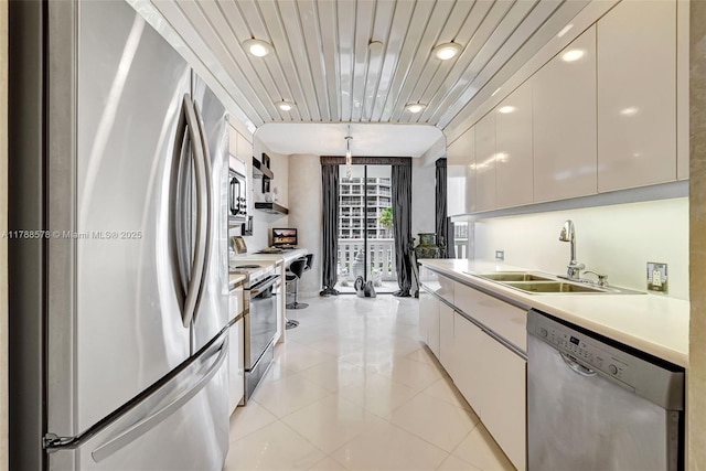 3000 Island Blvd Unit 706, Aventura, FL 33160 - kitchen featuring appliances with stainless steel finishes, a sink, modern cabinets, light countertops, and light tile patterned floors