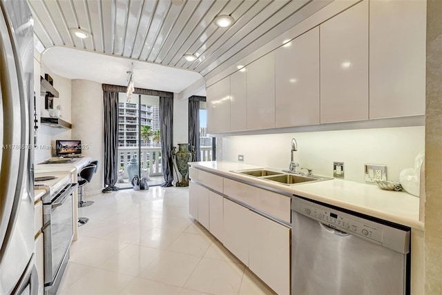 3000 Island Blvd Unit 706, Aventura, FL 33160 - kitchen with dishwasher, a sink, range with electric cooktop, light countertops, and light tile patterned flooring