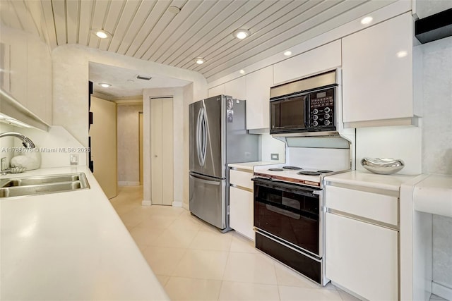 3000 Island Blvd Unit 706, Aventura, FL 33160 - kitchen with black microwave, range with electric stovetop, a sink, freestanding refrigerator, and light countertops