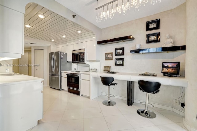 3000 Island Blvd Unit 706, Aventura, FL 33160 - kitchen featuring range with electric cooktop, freestanding refrigerator, black microwave, white cabinetry, and a sink