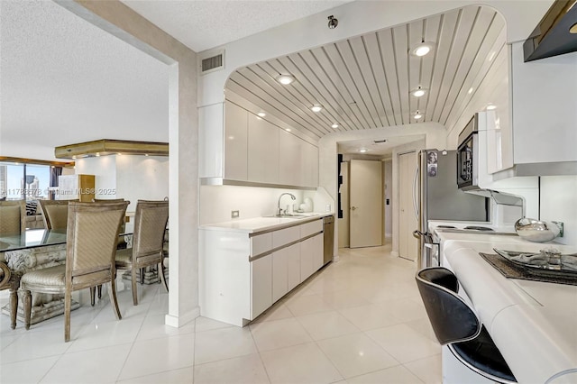 3000 Island Blvd Unit 706, Aventura, FL 33160 - kitchen featuring light countertops, modern cabinets, stainless steel dishwasher, white cabinetry, and a textured ceiling
