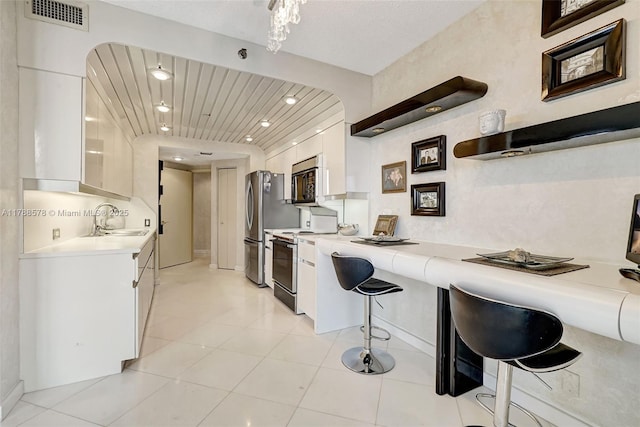 3000 Island Blvd Unit 706, Aventura, FL 33160 - kitchen with stainless steel appliances, a sink, white cabinets, light countertops, and recessed lighting