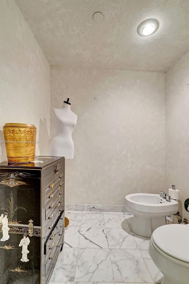 3000 Island Blvd Unit 706, Aventura, FL 33160 - bathroom featuring toilet, a bidet, marble finish flooring, and baseboards