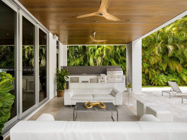 view of patio with grilling area, an outdoor kitchen, ceiling fan, and outdoor lounge area