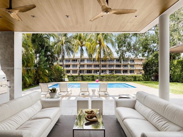 view of patio / terrace with an outdoor living space, a ceiling fan, and an outdoor pool