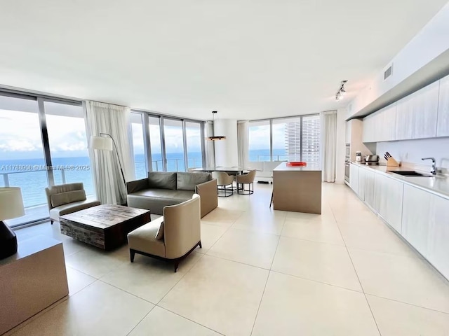 4111 S Ocean Dr Unit 1801, Hollywood, FL 33019 - living area with light tile patterned floors, rail lighting, visible vents, and a wealth of natural light
