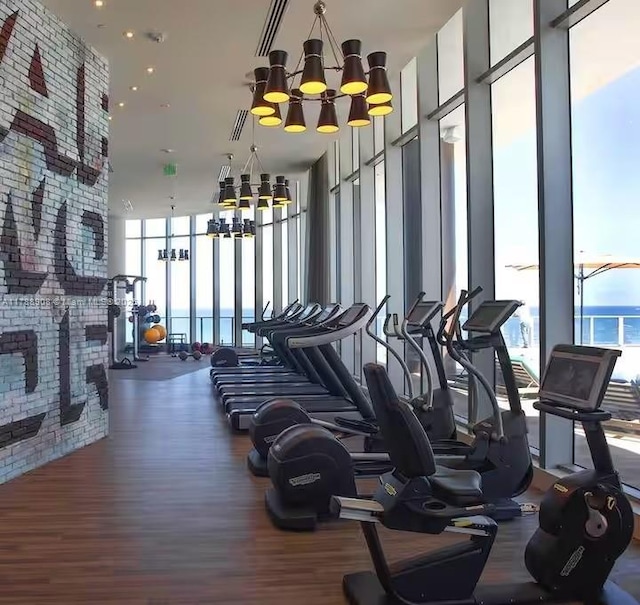4111 S Ocean Dr Unit 1801, Hollywood, FL 33019 - exercise room with a wall of windows, wood finished floors, and a chandelier