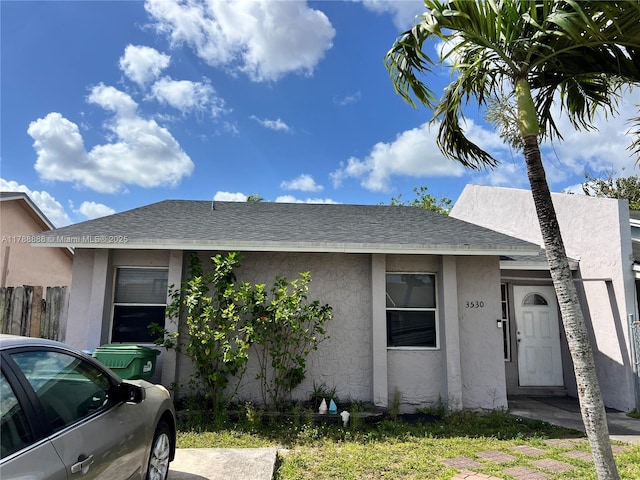 3530 NW 194th Ter, Miami Gardens, FL 33056 - ranch-style home featuring fence, roof with shingles, and stucco siding