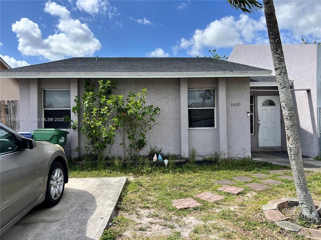 3530 NW 194th Ter, Miami Gardens, FL 33056 - view of front of home featuring roof with shingles and stucco siding