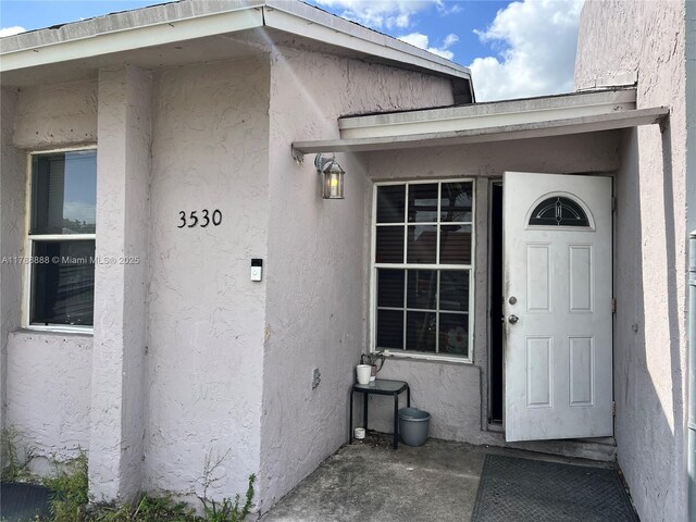 3530 NW 194th Ter, Miami Gardens, FL 33056 - doorway to property with stucco siding