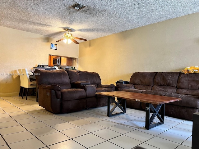 3530 NW 194th Ter, Miami Gardens, FL 33056 - living room with a textured ceiling, light tile patterned flooring, ceiling fan, a textured wall, and visible vents