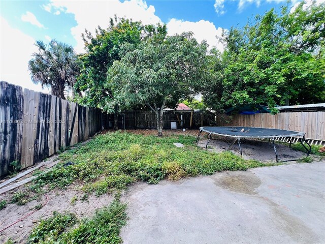 3530 NW 194th Ter, Miami Gardens, FL 33056 - view of yard featuring a fenced backyard and a trampoline