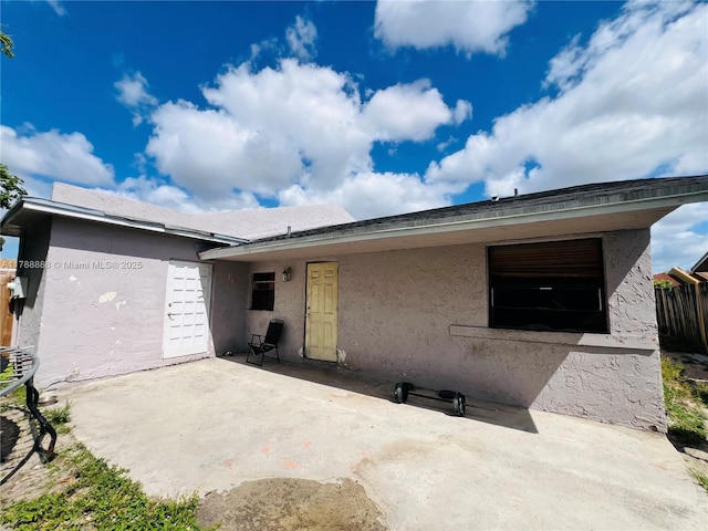 3530 NW 194th Ter, Miami Gardens, FL 33056 - back of property featuring a patio, stucco siding, and fence