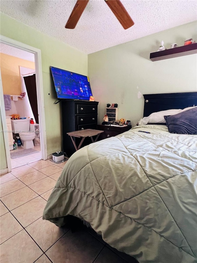3530 NW 194th Ter, Miami Gardens, FL 33056 - bedroom with a ceiling fan, light tile patterned flooring, a textured ceiling, and ensuite bathroom