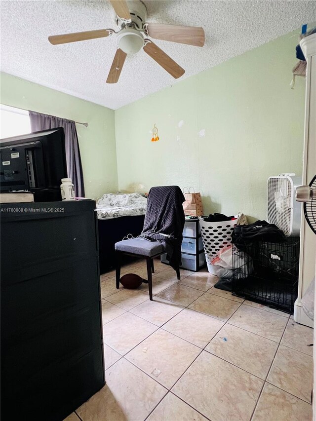 3530 NW 194th Ter, Miami Gardens, FL 33056 - bedroom featuring a ceiling fan, a textured ceiling, and light tile patterned floors