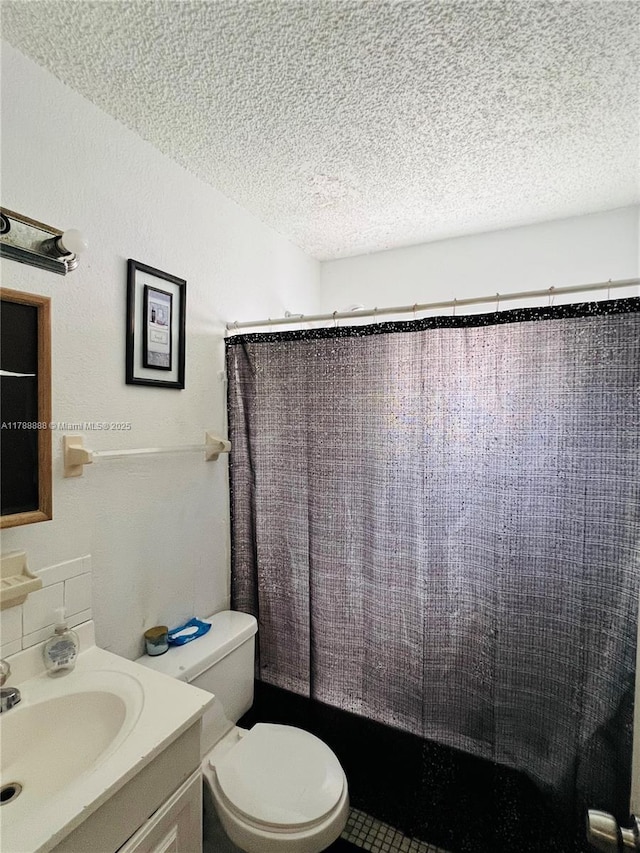 3530 NW 194th Ter, Miami Gardens, FL 33056 - bathroom featuring a textured ceiling, toilet, vanity, and shower / bath combo with shower curtain