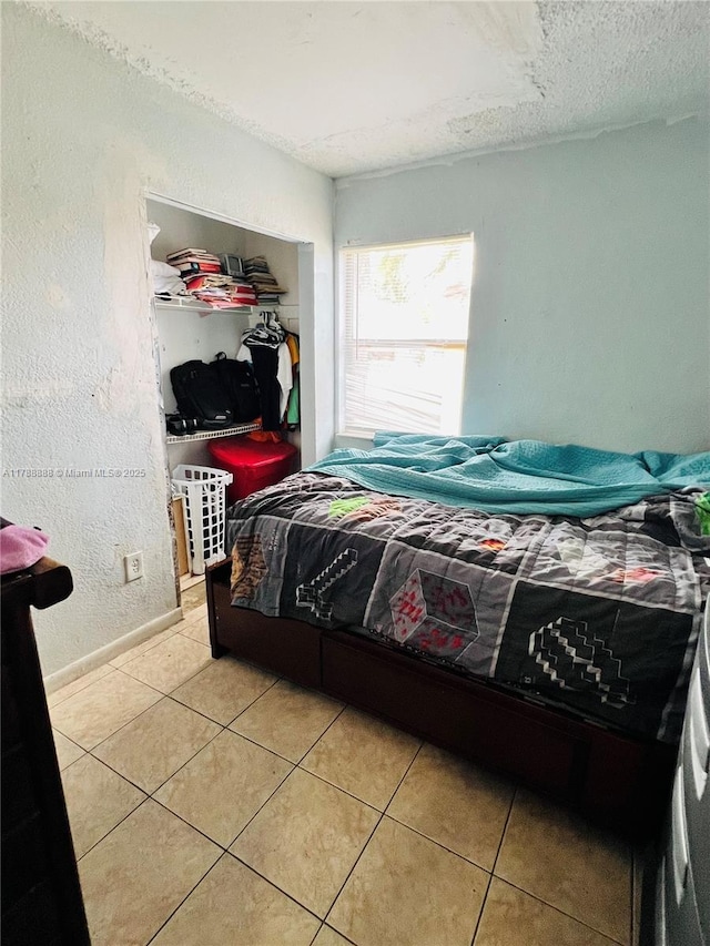 3530 NW 194th Ter, Miami Gardens, FL 33056 - bedroom with baseboards, a textured ceiling, and light tile patterned floors