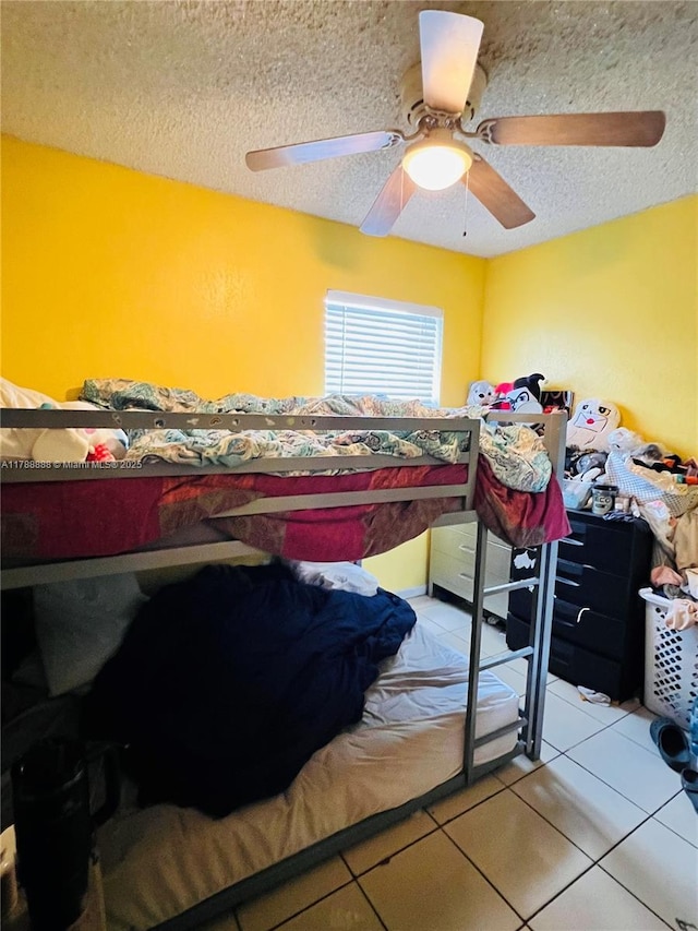 3530 NW 194th Ter, Miami Gardens, FL 33056 - bedroom featuring tile patterned flooring, a ceiling fan, and a textured ceiling