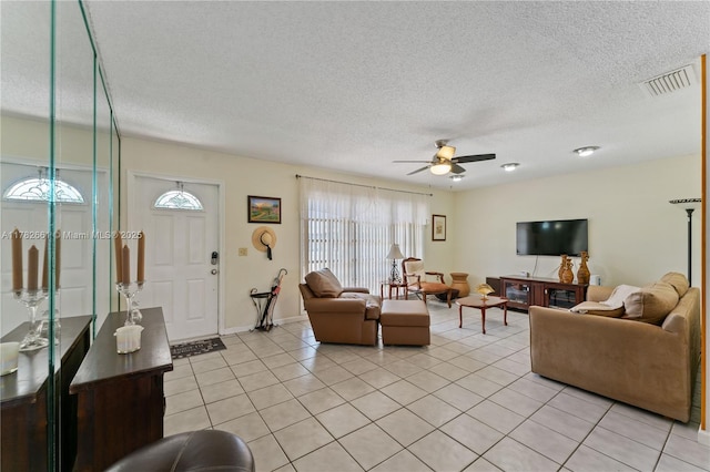 11421 NW 37th Pl, Sunrise, FL 33323 - living room featuring a ceiling fan, a textured ceiling, light tile patterned floors, and baseboards