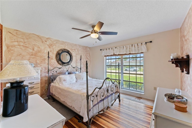 11421 NW 37th Pl, Sunrise, FL 33323 - bedroom with a textured ceiling, wood finished floors, and a ceiling fan