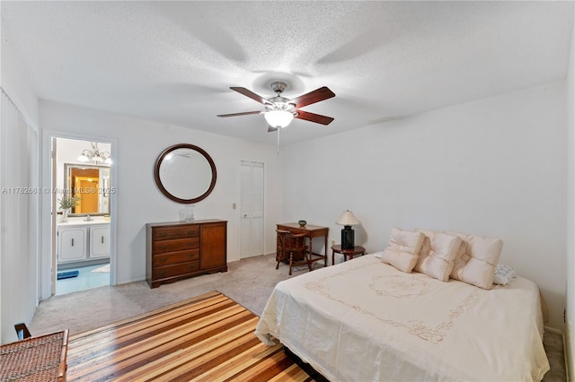 11421 NW 37th Pl, Sunrise, FL 33323 - bedroom with light carpet, a textured ceiling, ensuite bath, and a ceiling fan