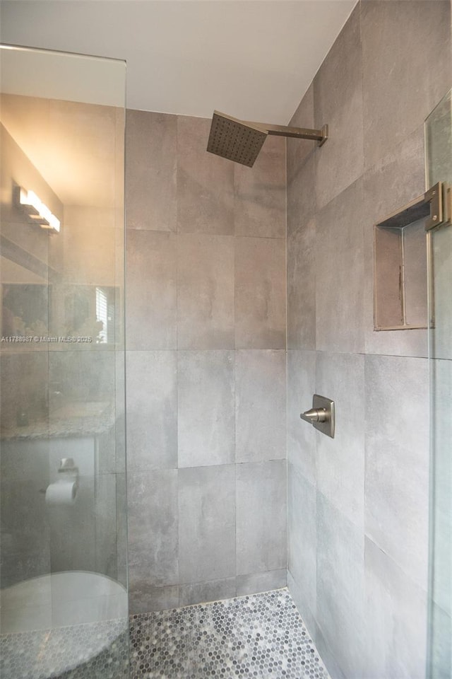 bathroom with a tile shower