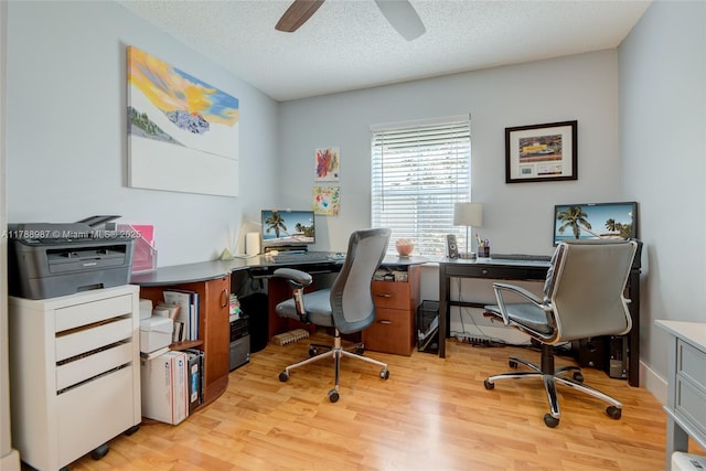 office area with a textured ceiling, ceiling fan, and light wood finished floors