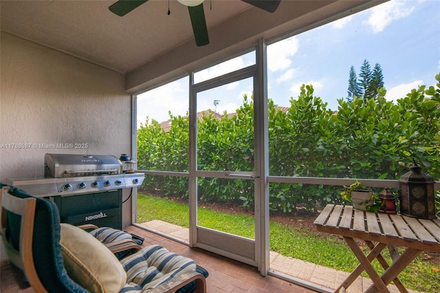 sunroom / solarium with a ceiling fan