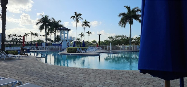 community pool featuring a patio and fence