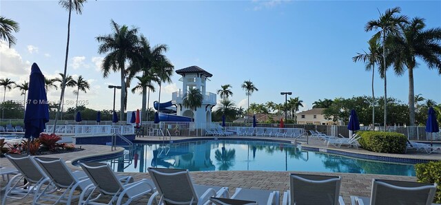 community pool featuring fence and a patio area